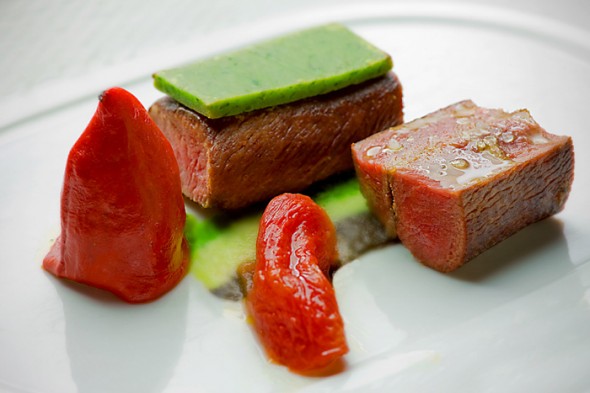 Roasted lamb loin with an herb crust, artichoke and an olive piquillo pepper. (Photo By: Scott Eklund/Red Box Pictures)