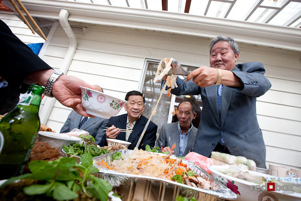 Family members dig into the feast on the deck at San's house. (Photo by Scott Eklund/Red Box Pictures)