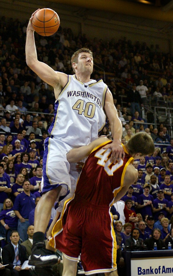 2008 winner Jon Brockman drives over USC's Greg Gaudino on the way to the basket in the game won by the UW over USC 87-73. (Scott Eklund/Seattle Post-Intelligencer)