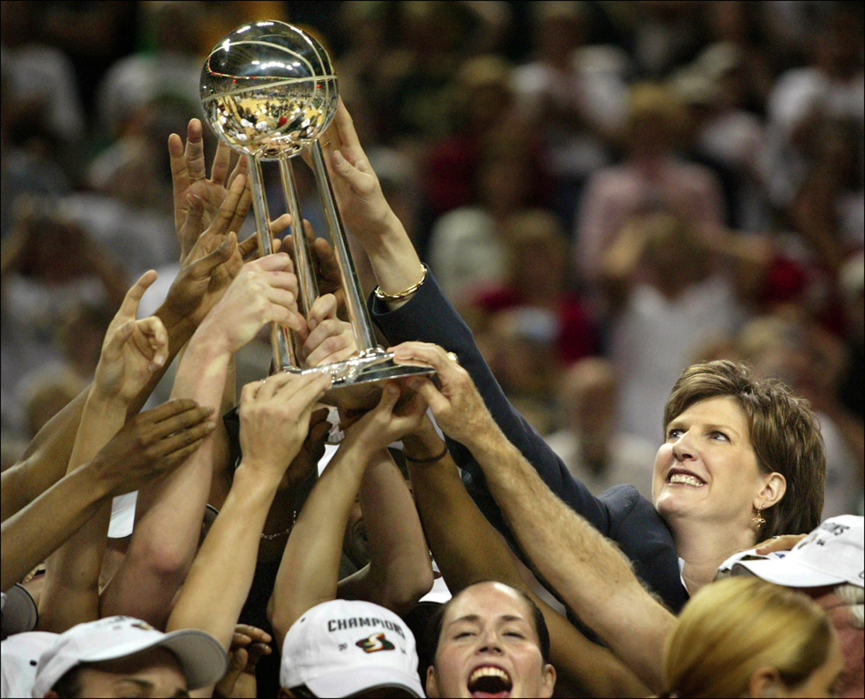 2004 SSY winner Seattle Storm Coach Anne Donovan reaches out to touch the championship trophy in 2004 as she became the first woman head coach to win the WNBA title. (Scott Eklund/Seattle Post-Intelligencer)