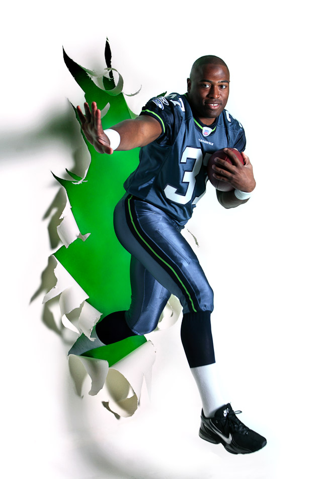 The 2005 Sports Star of the Year was Seahawks running back Shawn Alexander, photographed breaking out of the newspaper for a P-I season-opening special section in 2007. (Andy Rogers/Seattle Post-Intelligencer)