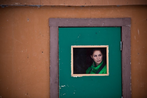 A friend watches the hockey game in Field, B.C. (Photo by Andy Rogers/Red Box Pictures)