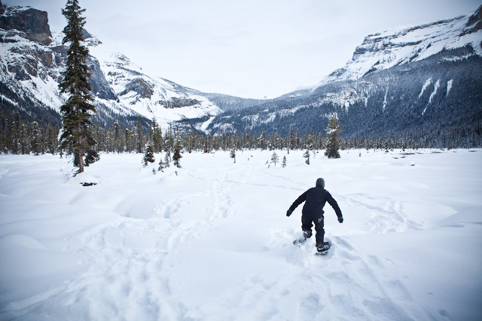 A wedding guest tromps through the snow covering Lake Louise in his snow shoes. (Photo by Andy Rogers/Red Box Pictures)