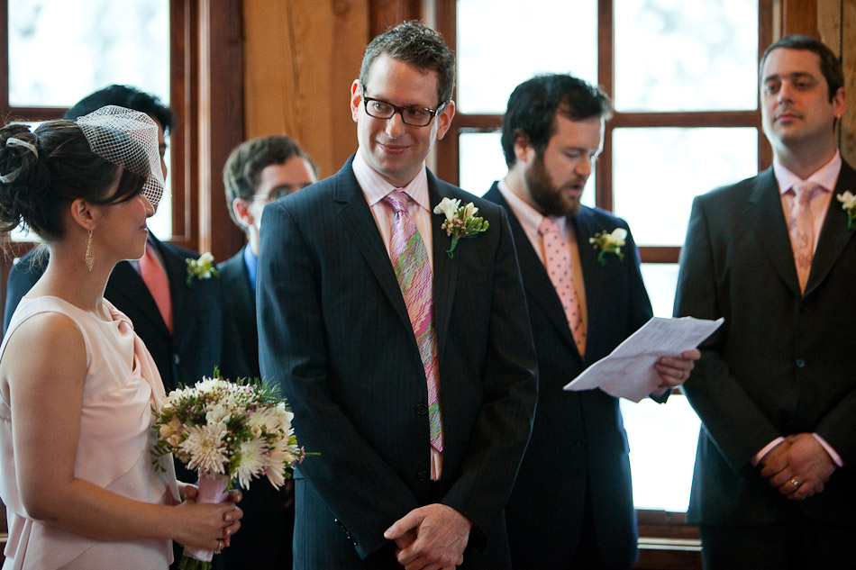 Steve looks at Karen as they listen to one of his groomsmen read a poem during their wedding ceremony at Emerald Lake Lodge in Yoho National Park, Canada. (Photo by Andy Rogers/Red Box Pictures)