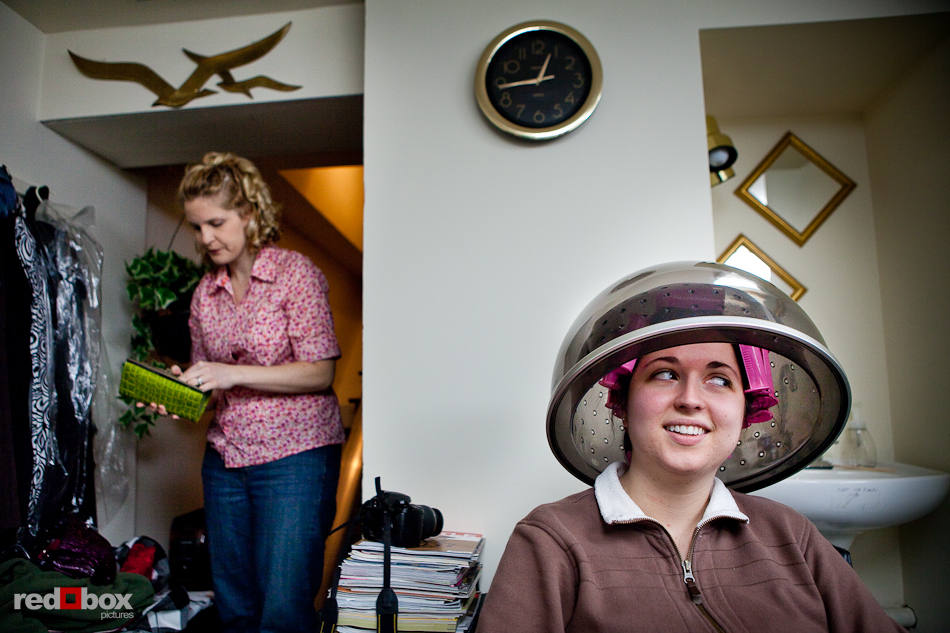 With pink curlers in her hair, bride Merilee sits beneath a hair dryer prior to her wedding at Hillcrest Lodge in Mt. Vernon, WA. (Photography by Andy Rogers/Red Box Pictures)