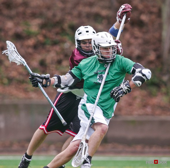 The Buckley's Lacrosse Club attacker dodges a Coopers defender during their game at Queen Anne Bowl in Seattle. (Photo by Andy Rogers/Red Box Pictures)