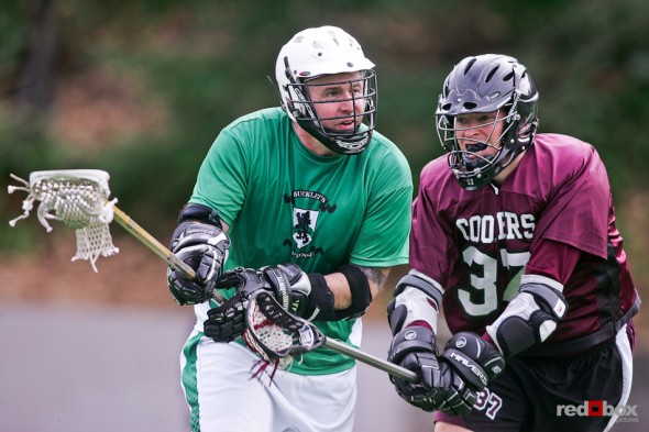 A Buckley's Lacrosse Club defender tries to clear the ball against Cooper's at Queen Anne Bowl in Seattle. (Photo by Andy Rogers/Red Box Pictures)