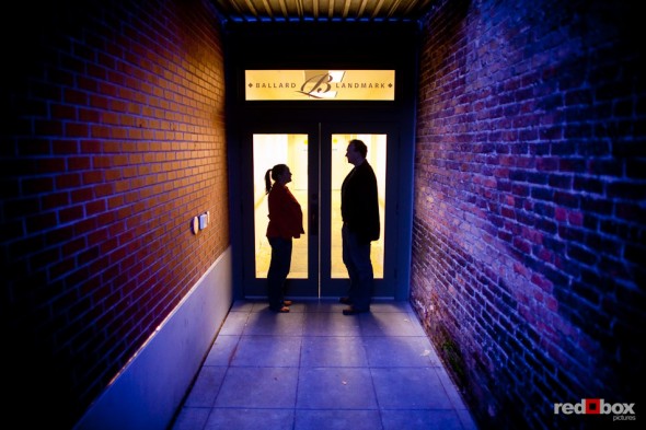 A silhouette of Tara and Brian in one of the apartment building entrances in old Ballard during their Seattle engagement portrait session. (Photography by Andy Rogers/Red Box Pictures)
