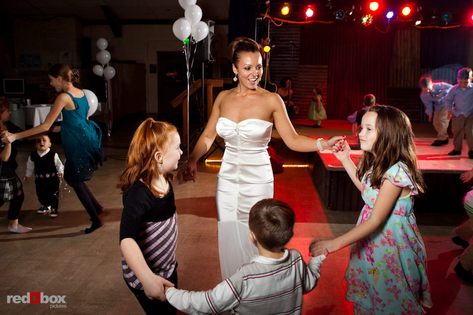 The bride, Andrea, dances with guests during Andrea and Bill's wedding reception in Tukwila, near Seattle. (Photo by Dan DeLong/Red Box Pictures)