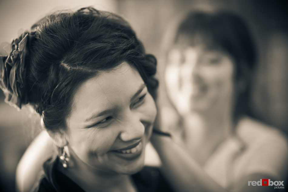 Sarah has her hair touched up by a brides maid prior to her wedding at the Lake Union Cafe in Seattle. (Photo by Andy Rogers/Red Box Pictures)