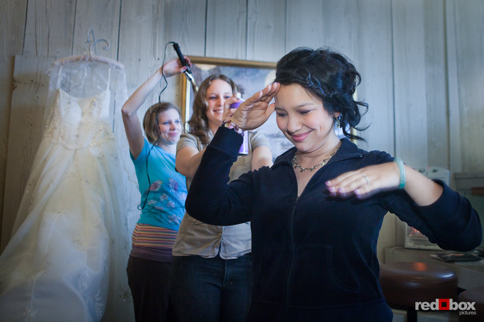 In the bride's room at the Lake Union Cafe, Sarah's bridesmaid applies hair spray prior to her wedding in Seattle. (Photo by Rob Sumner/Red Box Pictures)