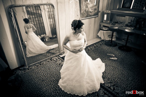 Sarah stands in the bride's room at the Lake Union Cafe after putting on her wedding dress in Seattle. (Photo by Andy Rogers/Red Box Pictures)