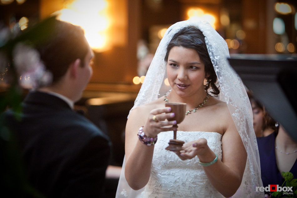 Sarah takes a goblet of wine during her wedding ceremony at the Lake Union Cafe in Seattle. (Photo by Andy Rogers/Red Box Pictures)