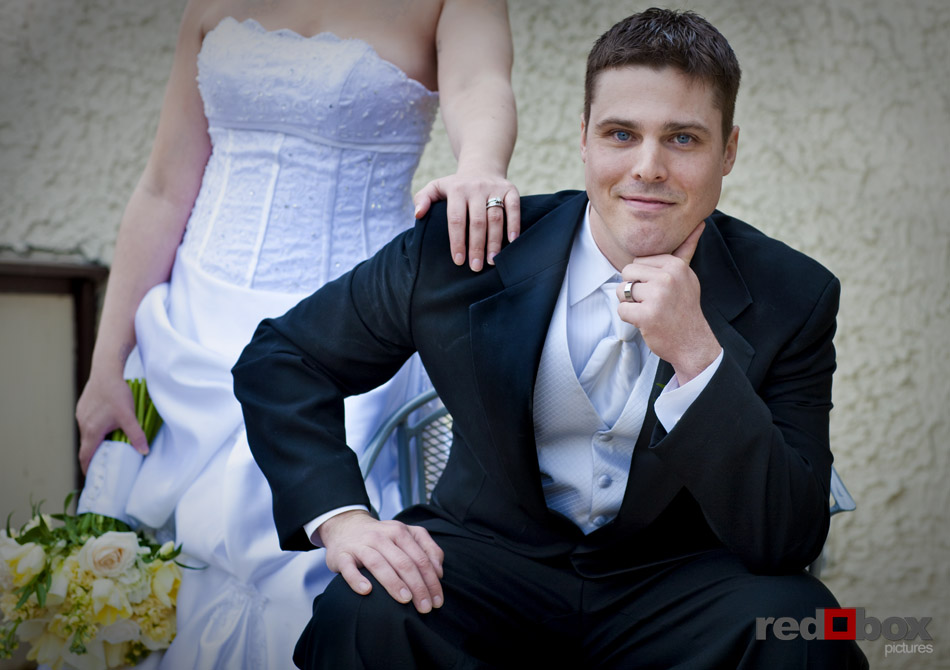A portrait of the groom with the bride behind him before the wedding in Seattle on Capitol Hill at the Bacon Mansion. Wedding Photographer Scott Eklund Red Box Pictures