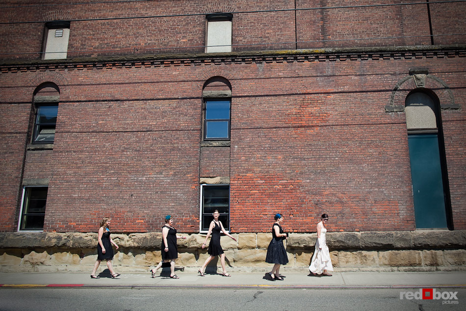 Niki and her bridesmaids walk past the old Rainier Brewery on their way to Jules Maes Saloon to meet Shawn and the boys. (Photography by Andy Rogers/Red Box Pictures)
