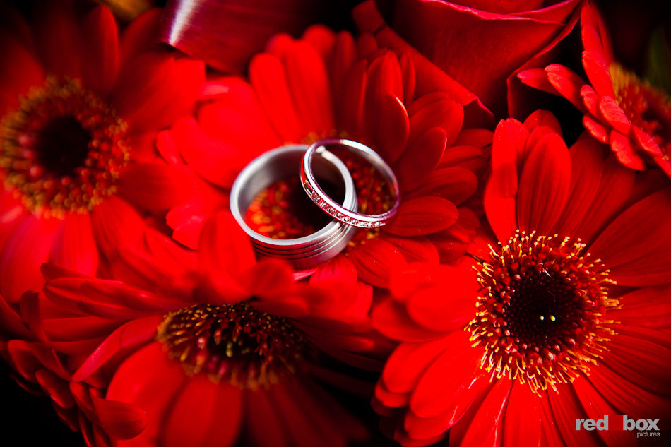 Tara and Rob rings are photographed with centerpiece flowers during their reception in the Chinese Room of the Smith Tower in downtown Seattle. (Photo by Dan DeLong/Red Box Pictures)