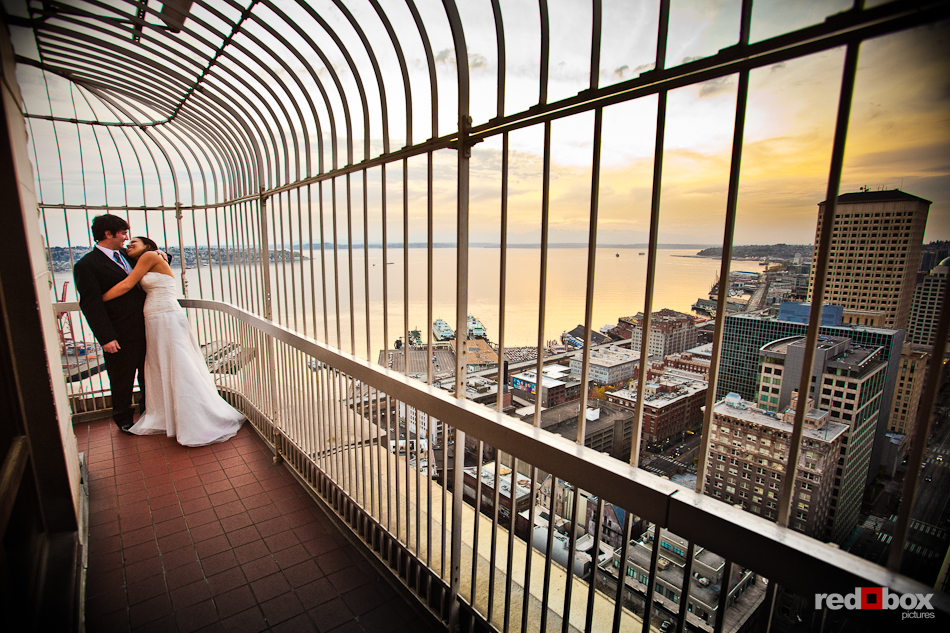 Tara and Rob share a moment on the Smith Tower observation deck during their wedding receptionin downtown Seattle. (Photo by Dan DeLong/Red Box Pictures)