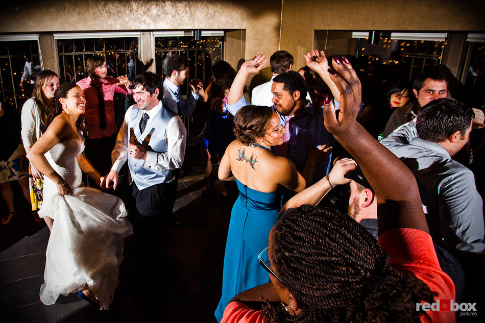 Tara and Rob dance with guests during their wedding reception in the Chinese Room of the Smith Tower in downtown Seattle. (Photo by Dan DeLong/Red Box Pictures)