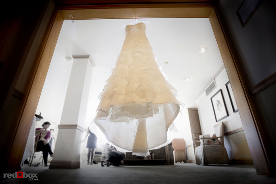 The wedding dress hangs in the room at Semiahmoo Resort in Blaine, WA. Seattle Wedding Photographer Scott Eklund Red Box Pictures