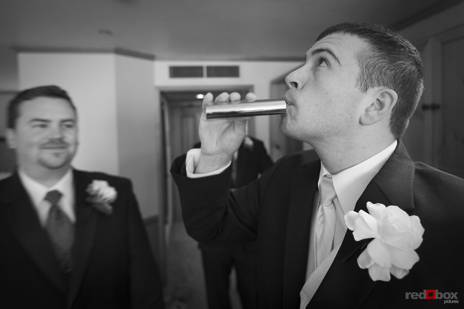 The groom takes a shot from a hip flask at Semiahmoo Resort in Blaine, WA. Seattle Wedding Photographer Scott Eklund Red Box Pictures