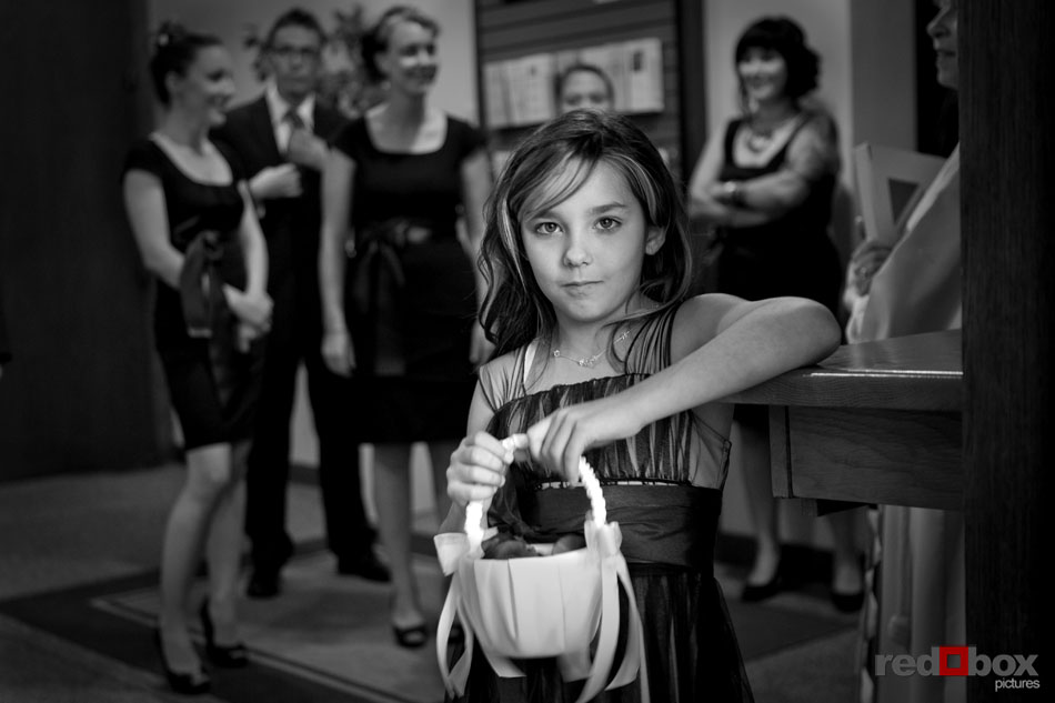 The flower girl waits for her turn to walk down the aisle at St. Mark's Cathedral in Seattle, Wash. Wedding Photography Scott Eklund/Red Box Pictures