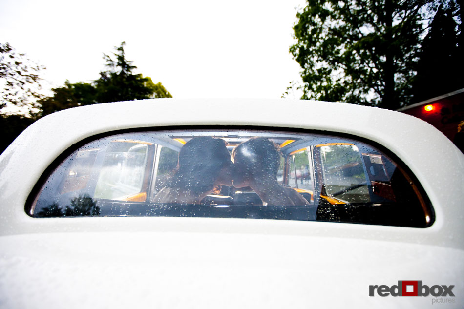 The two brides kiss in the back seat of a Rolls Royce after their wedding at St. Mark's Cathedral in Seattle, Wash. Wedding Photography Scott Eklund/Red Box Pictures