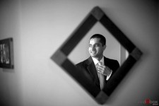 Neel makes a few last minute adjustments before his wedding at St. Louise Catholic Church in Bellevue. (Wedding Photographer Scott Eklund Red Box Pictures)