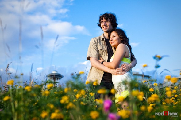 While being photographed for their engagement, Anghi and Andy enjoy the setting sun from the Seattle Art Museum Sculpture Park. Photo by Dan DeLong/Red Box Pictures