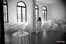 Kate takes a peek at the decor before her wedding at the Engine Room at Georgetown Studios in Seattle. (Photo by Dan DeLong/Red Box Pictures)