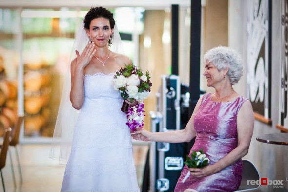 Laura becomes emotional as her mother look on before walking down the aisle to marry Nathan at the Novelty Hill Januik Winery in Woodinville, WA.