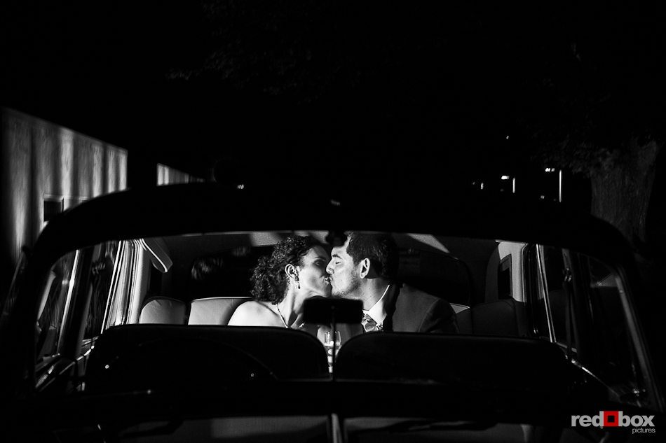 Nathan and Laura kiss in a limo before departing following their wedding and reception at the Novelty Hill Januik Winery in Woodinville, WA.