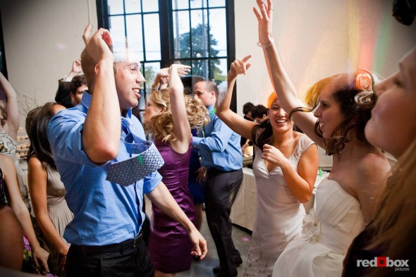 Guests dance to the tunes at Kate and Dan's wedding reception in the Georgetown Studios' Engine Room in Seattle. (Photography by Andy Rogers/Red Box Pictures)