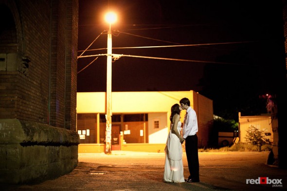 Kate and Dan steal away for a kiss during their wedding reception at the Engine Room at the Georgetown Studios in Seattle. (Photo by Dan DeLong/Red Box Pictures)