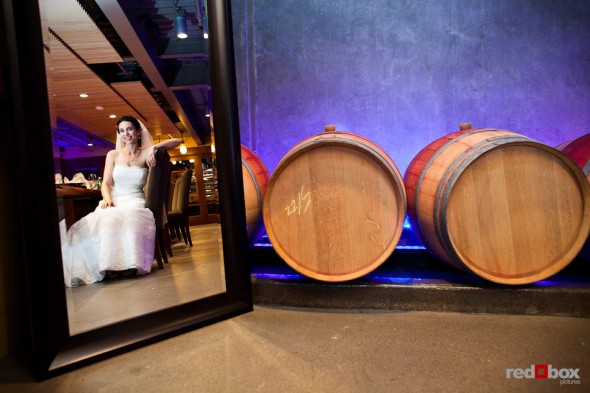 Laura, the bride, is reflected in a mirror just before her wedding to Nathan at the Novelty Hill Januik Winery in Woodinville, WA. (Photo by Dan DeLong/Red Box Pictures)