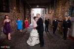 Maureen and Alex with their wedding party in Post Alley at the Pike Place Market prior to their wedding ceremony at the Georgetown Ballroom in Seattle. (Photo by Andy Rogers/Red Box Pictures)