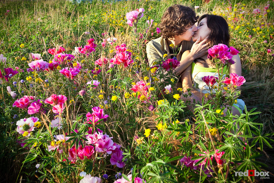 Anghi and Andy's kiss among the flowers at the Seattle Art Museum Sculpture Park during their engagement photo session. Photo by Dan DeLong/Red Box Pictures