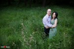 Nobuyo and Rory standing in the tall grass during their engagement portrait session at Seward Park in Seattle. (Photography by Andy Rogers/Red Box Pictures)
