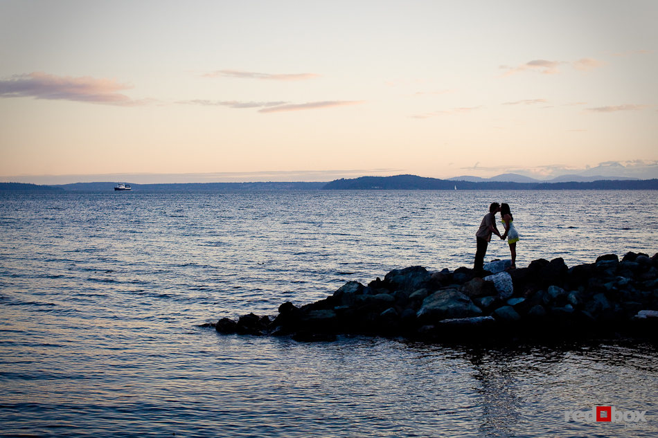 Anghi and Andy kiss at dusk in Myrtle Edwards Park in Seattle. The couple choose the park for their engagement pictures. Photo by Dan DeLong/Red Box Pictures