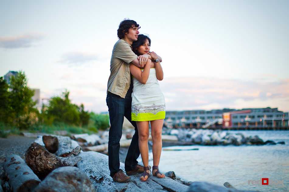 Anghi and Andy watch the sunset over the Puget Sound in Seattle while posing for their engagement pictures. Photo by Dan DeLong/Red Box Pictures