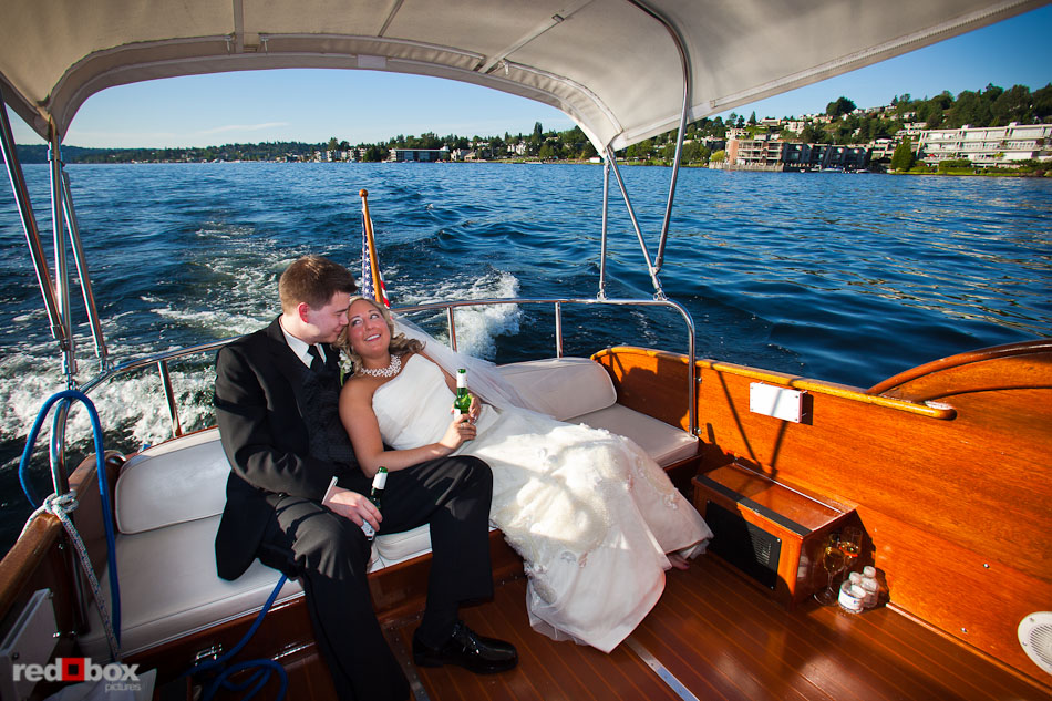Rachel and Shawn enjoy food and champagne aboard the Woodmark II cruise on Lake Washington after their wedding ceremony at the Woodmark Hotel in Kirkland, WA. (Photography by Andy Rogers/Red Box Pictures)