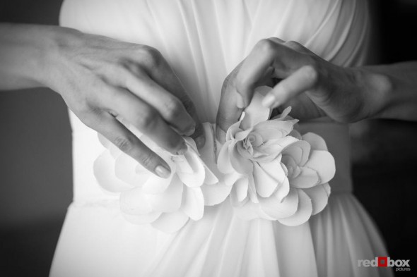 Kate attaches flowers to her dressing before her wedding at the Sheraton Hotel in Seattle. (Photo by Dan DeLong/Red Box Pictures)