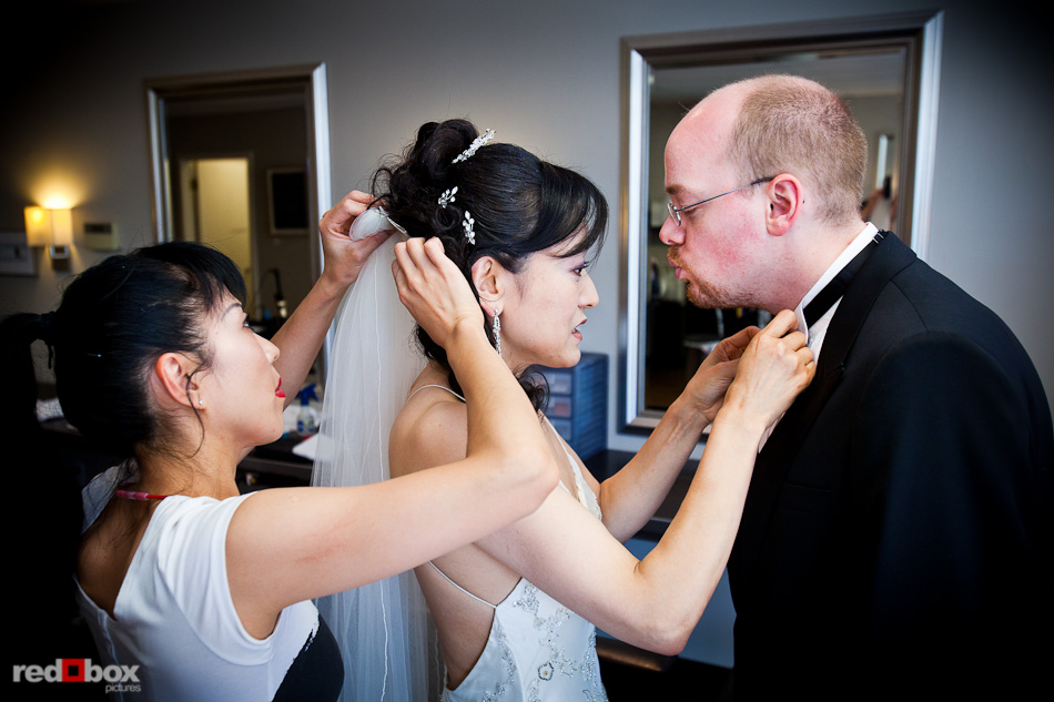 Nobuyo has finishing touches put on her hair as she fixes Rory's bow tie at Adore in Seattle prior to their Virginia V wedding. Photo by Seattle wedding photographer Andy Rogers of Red Box Pictures.