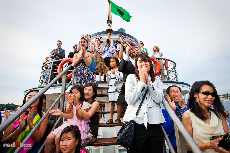 Guests celebrate Nobuyo and Rory's kiss after the couple's wedding aboard the Virginia V steamship on Lake Union in Seattle. (Photo by Dan DeLong/Red Box Pictures)