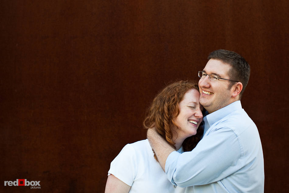 Katherine and Bryan hug during their engagement pictures at the Seattle Art Museum's Olympic Sculpture Park in Seattle. (Photo by Dan DeLong/Red Box Pictures)