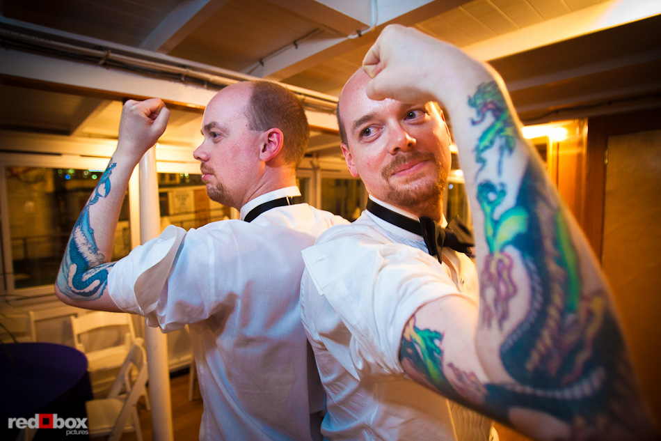 Rory (right) and his twin brother Ryan give in to requests that they show off matching dragon tattoos during Rory and Nobuyo's wedding reception aboard the Virginia V on Lake Union in Seattle. Photo by Seattle wedding photographer Andy Rogers of Red Box Pictures.