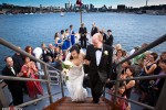 Nobuyo and Rory leave the deck following their wedding ceremony aboard the Virginia V on Lake Union in Seattle. Photo by Seattle wedding photographer Andy Rogers of Red Box Pictures.