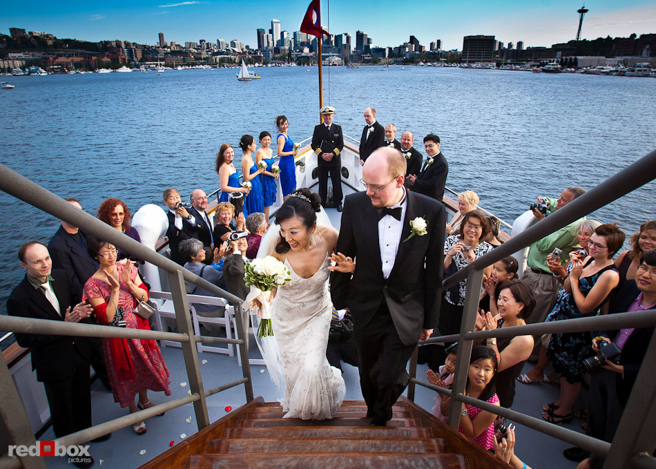 Nobuyo and Rory leave the deck following their wedding ceremony aboard the Virginia V on Lake Union in Seattle. Photo by Seattle wedding photographer Andy Rogers of Red Box Pictures.
