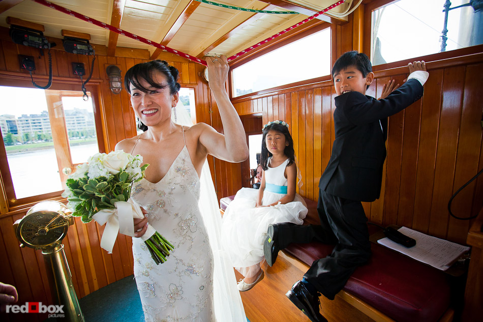 Nobuyo pulls the rope to trigger the Virginia V's steam whistle as the ship disembarks prior to her wedding ceremony and recpetion. Photo by Seattle wedding photographer Andy Rogers of Red Box Pictures.