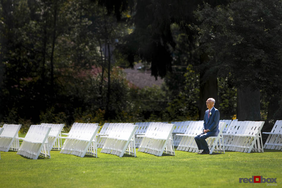 A family member waits for the start of the wedding at Inglewood Golf Club in Kenmore, Washington. Wedding Photographer Scott Eklund/Red Box Pictures/Seattle