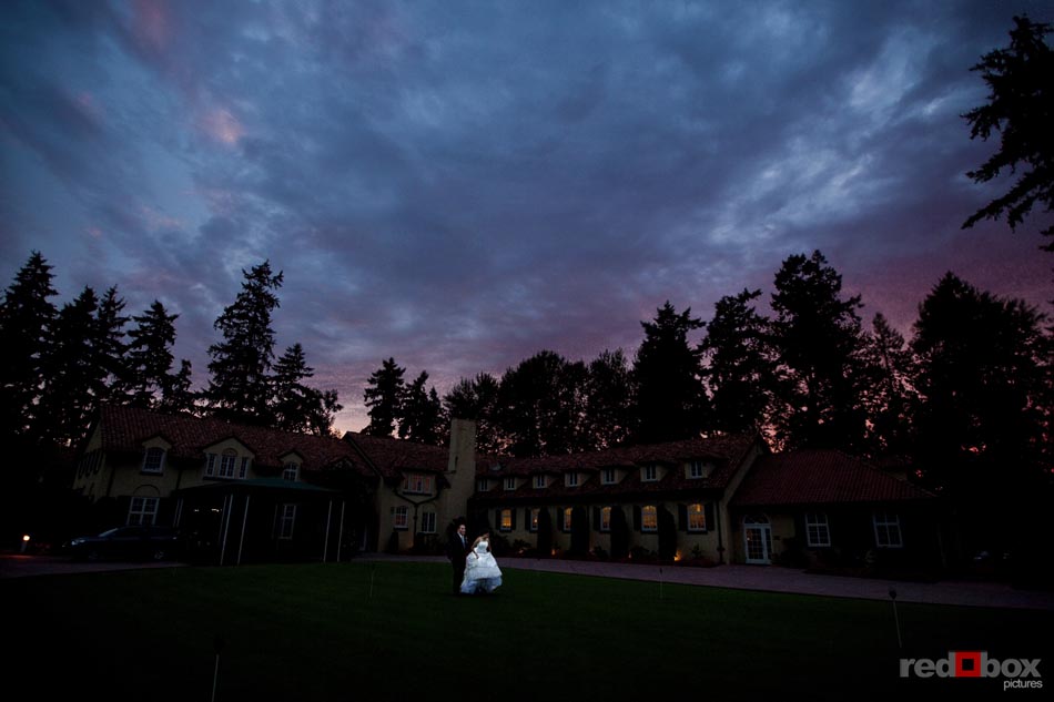 The bride & groom walk the grounds in front of the club house at the Inglewood Golf Club in Kenmore, Wash. (Wedding photography by Scott Eklund/Red Box Pictures Seattle, Wash.)